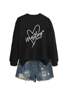 Flat lay detail of Wrestling Mom sweatshirt paired with distressed denim shorts