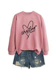 Flat lay detail of a dusty pink Wrestling Mom sweatshirt with ripped denim shorts