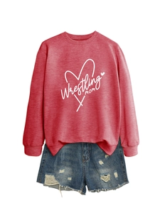 Detail of Wrestling Mom heart graphic on a long-sleeve sweatshirt with denim shorts