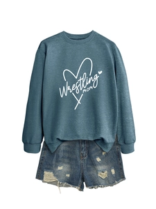 Close-up of a blue crewneck sweatshirt with Wrestling Mom heart print and distressed shorts