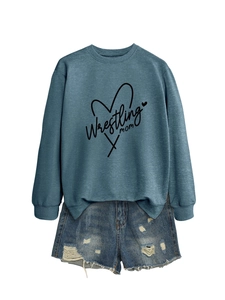 Detail of Wrestling Mom print on a blue long sleeve sweatshirt with denim shorts