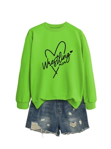 Close-up of neon green Wrestling Mom sweatshirt with distressed blue denim shorts set