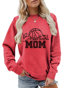 Close-up of red crewneck sweatshirt with black Basketball MOM print and cotton fabric texture