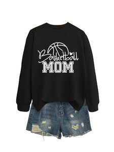 Flat lay of a black Basketball Mom crewneck sweatshirt with distressed denim shorts