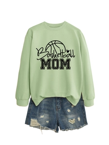 Detailed view of mint green Basketball Mom sweatshirt paired with distressed denim shorts