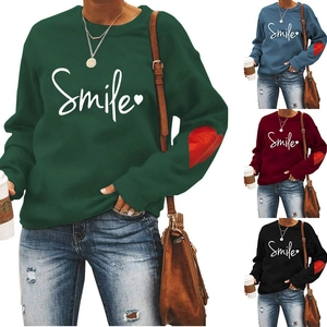 Close-up of Smile print and heart elbow patches on long sleeve crewneck sweatshirts