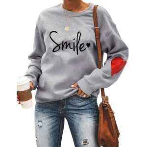 Detail of red heart patch on elbow and Smile print on gray cotton blend sweatshirt