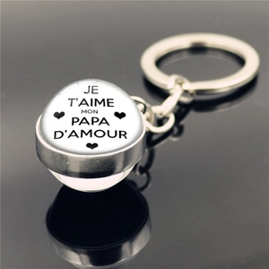 Macro shot of silver keychain with glass pendant featuring Je T'aime Mon Papa D'amour text