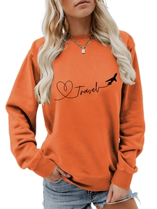 Detail of the screen-printed Travel logo and airplane silhouette on an orange sweatshirt