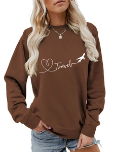 Detail of white Travel text and paper plane print on casual brown oversized sweatshirt