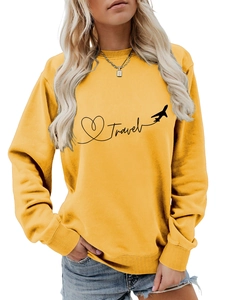Close-up of yellow Travel sweatshirt print with heart and airplane graphic details