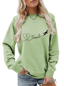 Detail of ribbed crew neck and black Travel airplane print on light green sweatshirt