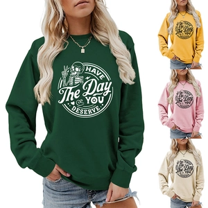 Detail of crewneck sweatshirt featuring skull graphic and Have the day you deserve text