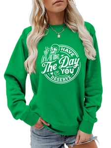 Close-up of skeleton print and text on bright green long sleeve crewneck sweatshirt