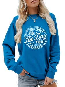 Detail of royal blue sweatshirt showing ribbed cuffs and HAVE THE DAY YOU DESERVE print