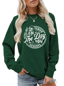 Detail of dark green crewneck sweatshirt with Have The Day You Deserve skeleton print