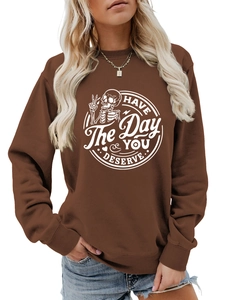 Detail of ribbed neckline and white screen-printed slogan on brown cotton sweatshirt