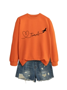 Flat lay of an orange Travel sweatshirt paired with distressed blue denim shorts