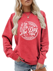 Detail of red crewneck sweatshirt featuring white skeleton peace sign and slogan print