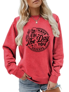 Detail of red crewneck sweatshirt featuring black skull graphic and street style print