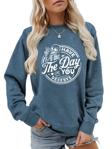 Close-up of blue-grey crewneck sweatshirt with skull hand print and white slogan text