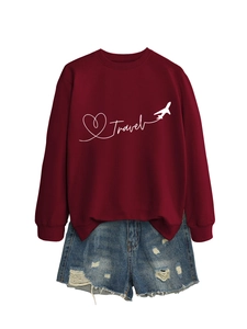 Flat lay of wine red sweatshirt with Travel print and distressed denim shorts set