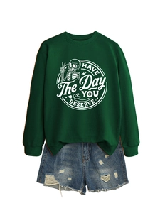 Detail of crewneck sweatshirt with 'Have the day you deserve' text and skull graphic