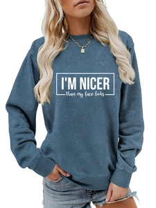 Detail of greyish blue crewneck sweatshirt with I'M NICER letter print and ribbed cuffs