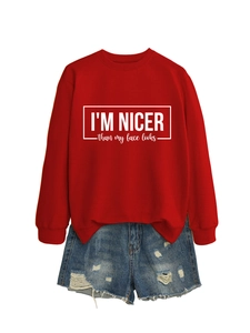 Detail of red crewneck sweatshirt with slogan print and distressed denim shorts