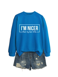 Detail of blue sweatshirt with slogan print and distressed denim shorts texture