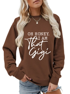 Detail of brown crewneck sweatshirt featuring white Oh Honey I Am That Gigi text print