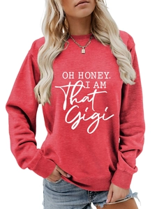 Detail of red long sleeve sweatshirt featuring white OH HONEY I AM THAT GIGI graphic text