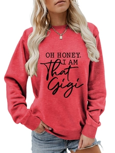 Detail of rust red crewneck sweatshirt with 'OH HONEY, I AM That Gigi' black print