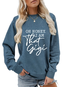 Detail of navy crewneck sweatshirt with white Oh Honey I Am That Gigi printed lettering