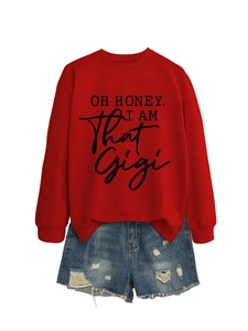 Detail of red crewneck sweatshirt with 'OH HONEY I AM THAT GIGI' text and denim shorts