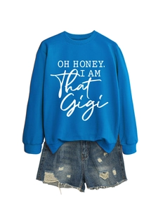 Detail of royal blue sweatshirt featuring white 'OH HONEY' typography with denim shorts