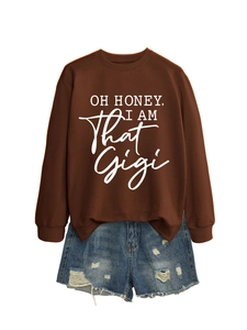 Detail of brown graphic sweatshirt featuring OH HONEY white lettering with denim shorts