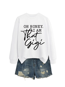 Flat lay of a white Gigi graphic sweatshirt and distressed blue denim shorts set