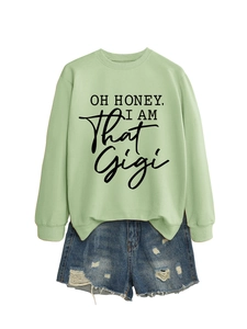 Detail of light green Gigi sweatshirt with ribbed cuffs and distressed denim shorts