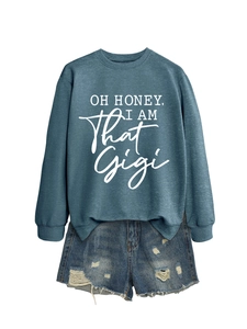 Detail view of casual blue sweatshirt with white text and distressed denim shorts with frayed edges
