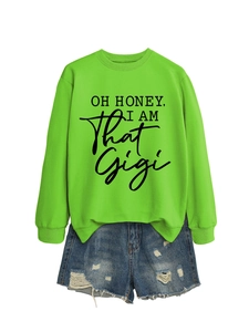 Flat lay of neon green sweatshirt with black text and ripped denim shorts on white background