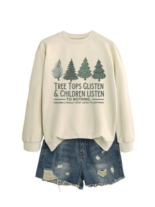 Dettaglio flat lay della felpa natalizia beige e degli shorts in denim consumati