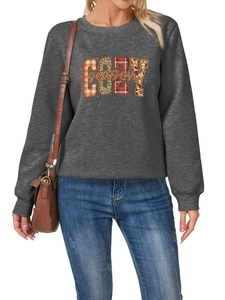 Detalle del estampado COZY season en sudadera gris con motivos de cuadros leopardo y maple