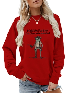 Close-up of cowboy frog graphic and slogan print on red crewneck sweatshirt