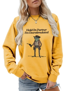 Detail of yellow sweatshirt with funny cartoon frog and Hold On Partner text print