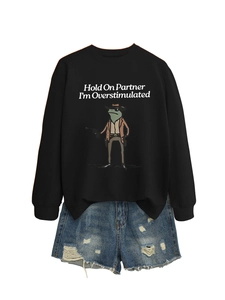 Detail of funny frog illustration and text print on black cotton sweatshirt with denim shorts