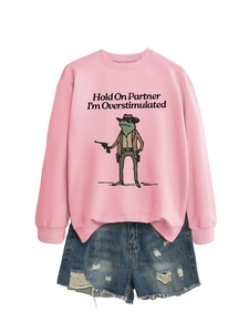 Pink sweatshirt featuring cowboy frog graphic paired with distressed denim shorts