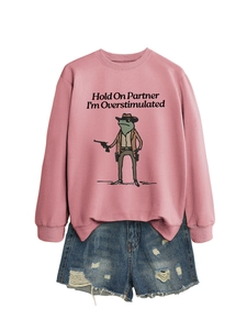 Flat lay of pink Hold On Partner graphic sweatshirt and distressed denim shorts set