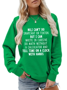 Close-up of green crewneck sweatshirt featuring white humor text print and necklace detail