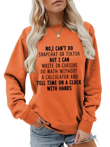 Detail showing the black typography print on an orange crewneck sweatshirt with necklace